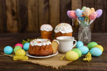 Easter cake and colorful eggs on a wooden table. It can be used as a background