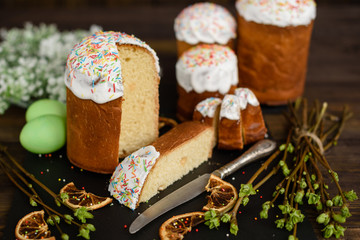 Easter cake and colorful eggs on a wooden table. It can be used as a background