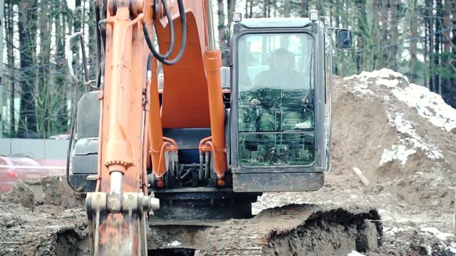 Loader backhoe, excavator digging a trench. Clip. Work of excavating machine on building construction site. Excavator digs a hole
