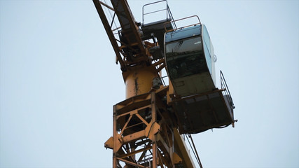 Fototapeta na wymiar Industrial yellow crane and sky on construction. Clip. Tower yellow crane