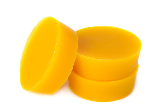 Pieces of natural beeswax are isolated on a white background. Beekeeping products. Apitherapy.