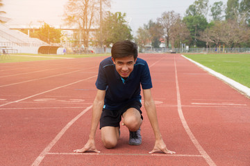 Asian man ready start run on track stadium