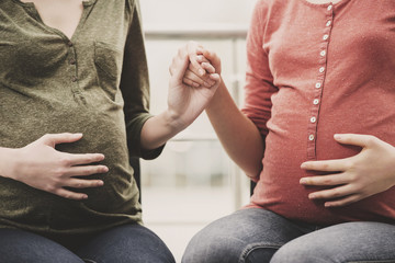 Close-up portrait of bellies of two pregnant women