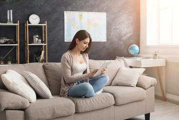 Fototapeta premium Young woman at home with tablet