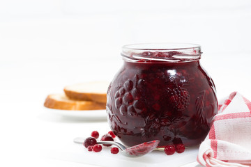 jar of cranberry jam on a white table, closeup
