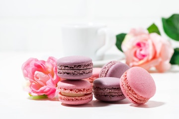 macaroon cookies and flowers on white table