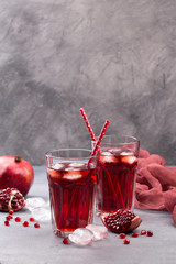 Fresh red lemonade with pomegranate and ice in glass
