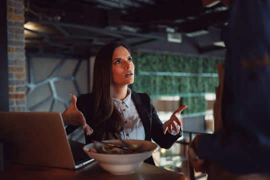 Portrait of woman complaining about food quality and taste in restaurant.