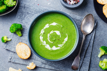 Broccoli cream soup in a bowl with toasted bread. Top view. Copy space.