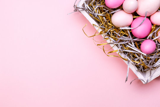 Eggs in a white tray. Creative Easter concept. Modern solid pink background.