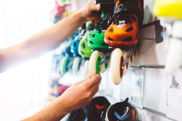 Assortment roller skates isolated in store shop, person choosing and buy color roller-skates on...
