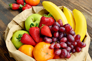 5 kind fresh  fruits in brown paper bag.
Mixed and colorful of fruits