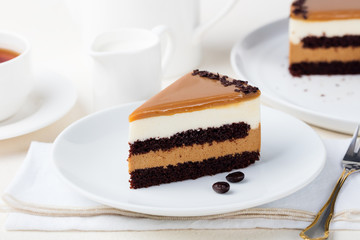 Caramel cake, mousse dessert on a plate. White background.