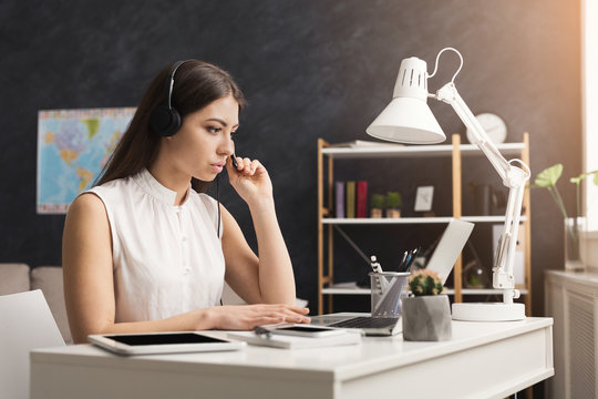 Serious Young Customer Service Operator Girl Working On Laptop