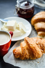 coffee with croissants oil and jam on the table. 