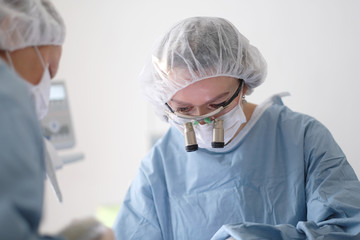 Doctor and assistant during implant placement in a dental clinic