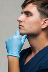 young surgeon on white background