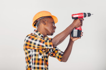African American worker uses electric screwdriver