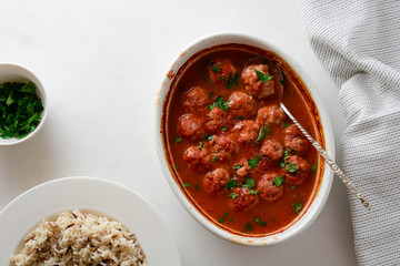 Meatballs in a spicy tomato sauce with fresh aromatic herbs. Rice and pasta.