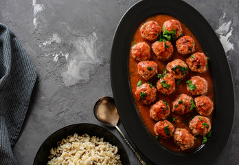 Meatballs in a spicy tomato sauce with fresh aromatic herbs. Rice and pasta.