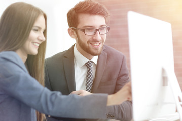 colleagues discussing information on a computer