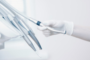 Stomatological instrument in dentists clinic. Doctor dentist takes hand instrument