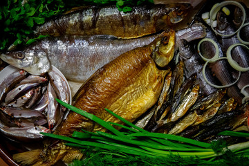 Smoked and salted river fish in the range served with vegetables and herbs. The view from the top.