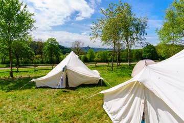 white tents in a scout camp - Powered by Adobe