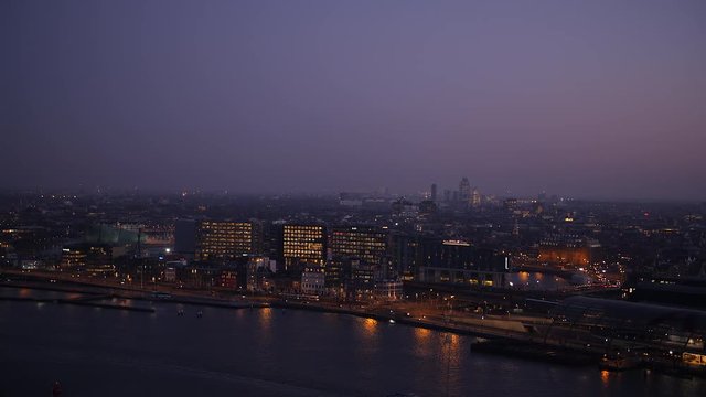Amsterdam aerial evening view looking across historic city and part of central train station.