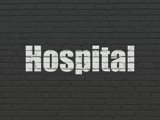 Obraz premium Medicine concept: Painted white text Hospital on Black Brick wall background