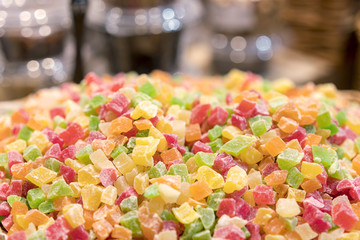 Fresh multi-colored candied fruits in a wicker basket