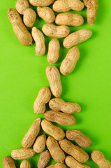 Peanuts on a bright green background.