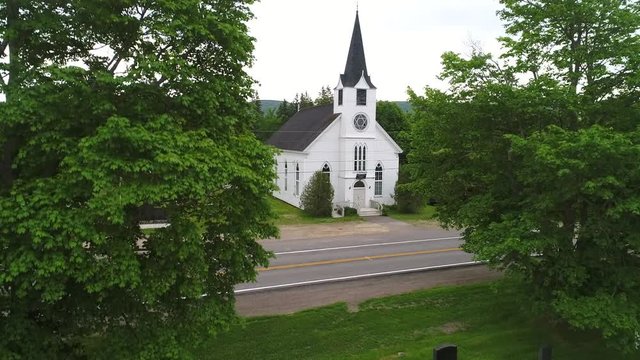 Aerial of small white church in the rural countryside