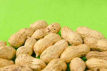Peanuts on a bright green background.
