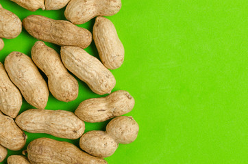 Peanuts on a bright green background.