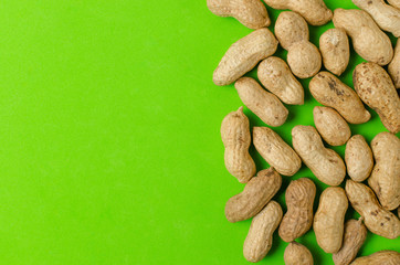 Peanuts on a bright green background.