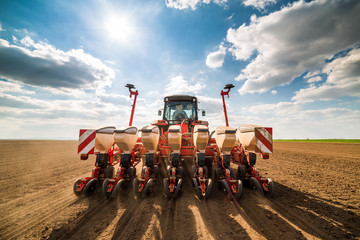 Farmer seeding, sowing crops at field. Sowing is the process of planting seeds in the ground as...