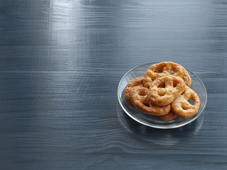 Homemade cookies on a transparent glass plate on a wooden table