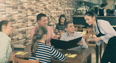 Waitress taking order from guests