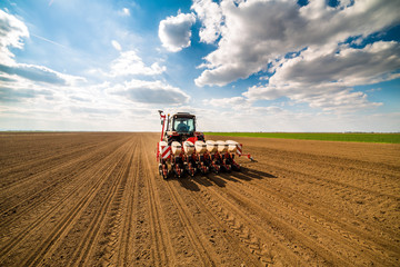 Farmer seeding, sowing crops at field. Sowing is the process of planting seeds in the ground as...