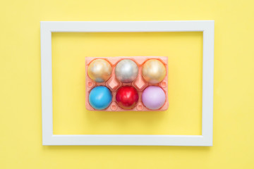 Flat lay top view colorful easter egg painted in pastel colors composition on yellow pastel color background. Easter day background top view with copy space.