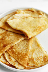 Macro shot of pancakes stacked in white plate