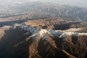 Fototapeta na wymiar Baetic Cordillera mountains with snow on mountain peak seen from an airplane