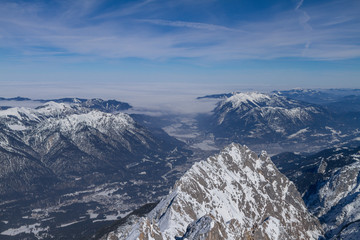 Fototapeta na wymiar Snowy Winter View From the Zugspitze To Grainau