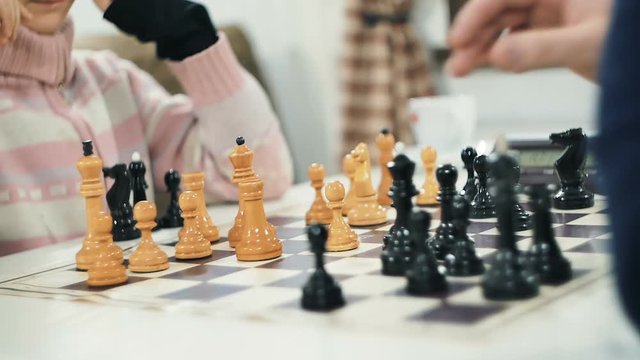 father and child playing chess