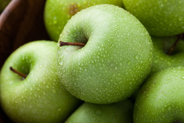 Close-up of ripe green apples covered with dew. Macro