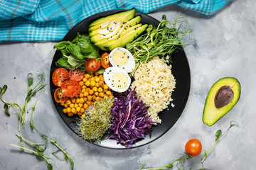 Healthy vegan lunch bowl. Vegan buddha bowl. Vegetables and nuts in buddha bowl on concrete...