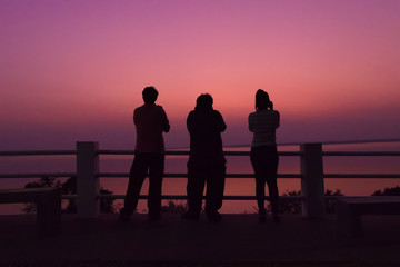 Fototapeta na wymiar Silhouette photographer shooting sunset