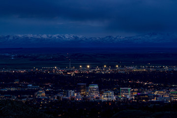 Fototapeta na wymiar Boise city at night with the Owyhee mountains with snow and night sky