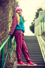 Woman wearing warm sportswear relaxing after exercising